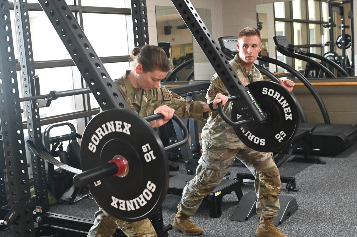 Staff Sgt. Taylor E. Linkous, S5/ Plans and Programs Officer assigned to the 42nd Security Forces Squadron trains with Capt. Ben T. Schmitt, Operational Support Team Physical Therapist, using OST equipment at the new centralized training center during a physical fitness session at Maxwell Air Force Base, Ala. April 22, 2024. This new area is open to all active-duty members from the designated unit who is assigned to the OST and who wants to improve their strength and conditioning, mental health, diet or overall physical well-being. (U.S. Air Force photo by Staff Sgt. Crystal A. Jenkins)