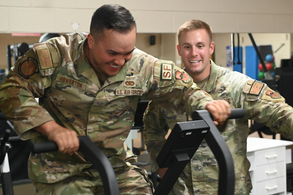 Senior Airman Michael J. Howerton, S4/Vehicle Control Officer assigned to the 42nd Security Forces Squadron trains with Capt. Ben T. Schmitt, Operational Support Team Physical Therapist using OST equipment at the new centralized training center during a physical fitness session at Maxwell Air Force Base, Ala. April 22, 2024. This new area is open to all active-duty members from the designated unit who is assigned to the OST and who wants to improve their strength and conditioning, mental health, diet or overall physical well-being. (U.S. Air Force photo by Staff Sgt. Crystal A. Jenkins)