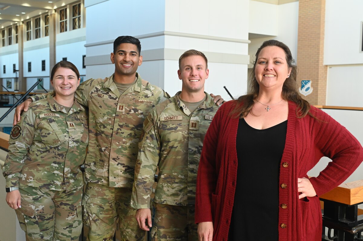 The Operational Support Team assigned to the 42nd Air Base Wing stands in front of the Mental Health area at the 42nd Medical Group at Maxwell Air Force Base, Ala. April 22, 2024. The OST is celebrating its fully operational status, as well as the opening of a new centralized resiliency center. The team is comprised of a specialist which is also an athletic trainer, a dietician, a social worker, a psychologist, a strength and conditioning coach, and a physical therapist. (U.S. Air Force photo by Staff Sgt. Crystal A. Jenkins)