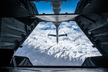 Aerial view of the snowy Sierra Nevada mountain range from the boom pod window.