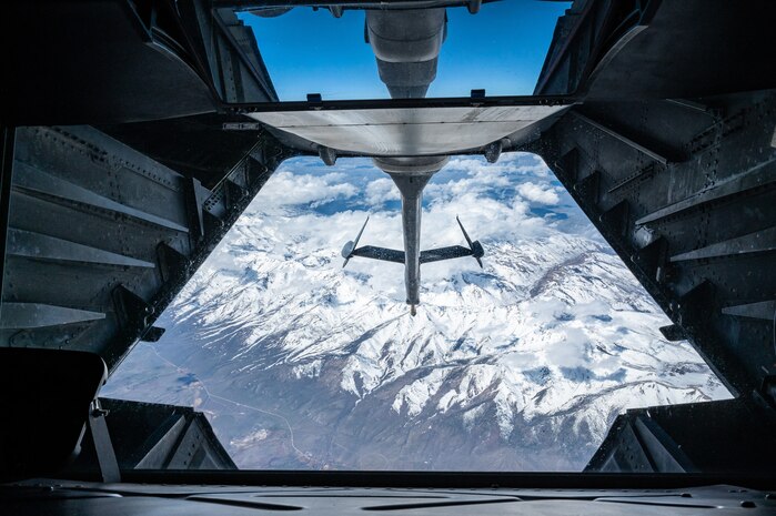 Aerial view of the snowy Sierra Nevada mountain range from the boom pod window.