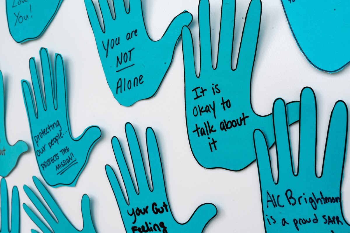 Paper cut-out hands hang in the Hoffman Auditorium