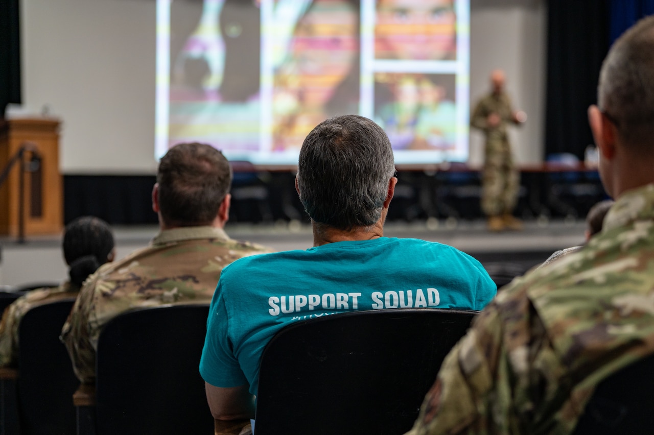 airmen sit in the audience to listen to a sapr brief