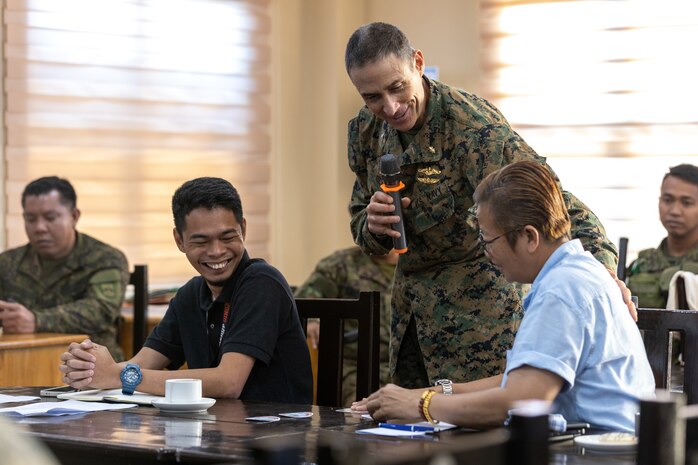 U.S. Navy Capt. Jason Blitz, the U.S. community health engagement lead with the Combined Joint Civil-Military Operations Task Force, speaks with Shiela H. Taay, the Dingalan municipal administrator, during a meeting at a community health engagement held before Exercise Balikatan 24 at the Dingalan Municipal Hall in Dingalan, Aurora, Philippines, April 5, 2024. BK 24 is an annual exercise between the Armed Forces of the Philippines and the  U.S. military designed to strengthen bilateral interoperability, capabilities, trust, and cooperation built over decades of shared experiences. (U.S. Marine Corps photo by Cpl. Trent A. Henry)