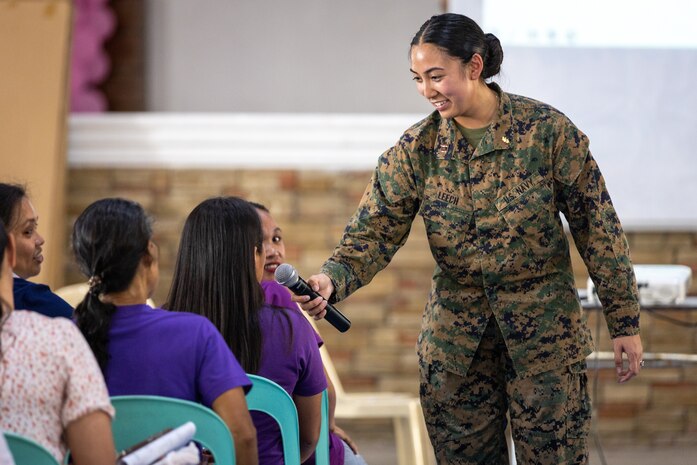 U.S. Navy Lt. Reena Mei Leech, an obstetrical and medical-surgical nurse with the Combined Joint Civil-Military Operations Task Force, engages with a local community  member while discussing women’s health during a community health engagement held before Exercise Balikatan 24 at the Dingalan Municipal Gymnasium in Dingalan, Aurora, Philippines, April 5, 2024. BK 24 is an annual exercise between the Armed Forces of the Philippines and the U.S. military designed to strengthen bilateral interoperability, capabilities, trust, and cooperation built over decades of shared experiences. (U.S. Marine Corps photo by Cpl. Trent A. Henry)