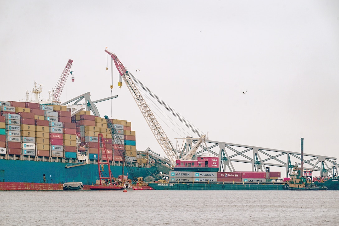 Salvors work on removing portions of the Francis Scott Key Bridge.