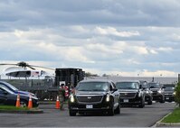 Airman 1st Class Robertino Molina, an installation entry controller assigned to the 175th Security Forces Squadron, Maryland Air National Guard, salutes President Biden’s motorcade as is passes heading to Baltimore with Maryland Gov. Wes Moore to assess the damage from the Francis Scott Key Bridge collapse, April 5, 2024 at Martin State Airport, Middle River, Md.