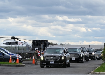 Airman 1st Class Robertino Molina, an installation entry controller assigned to the 175th Security Forces Squadron, Maryland Air National Guard, salutes President Biden’s motorcade as is passes heading to Baltimore with Maryland Gov. Wes Moore to assess the damage from the Francis Scott Key Bridge collapse, April 5, 2024 at Martin State Airport, Middle River, Md.