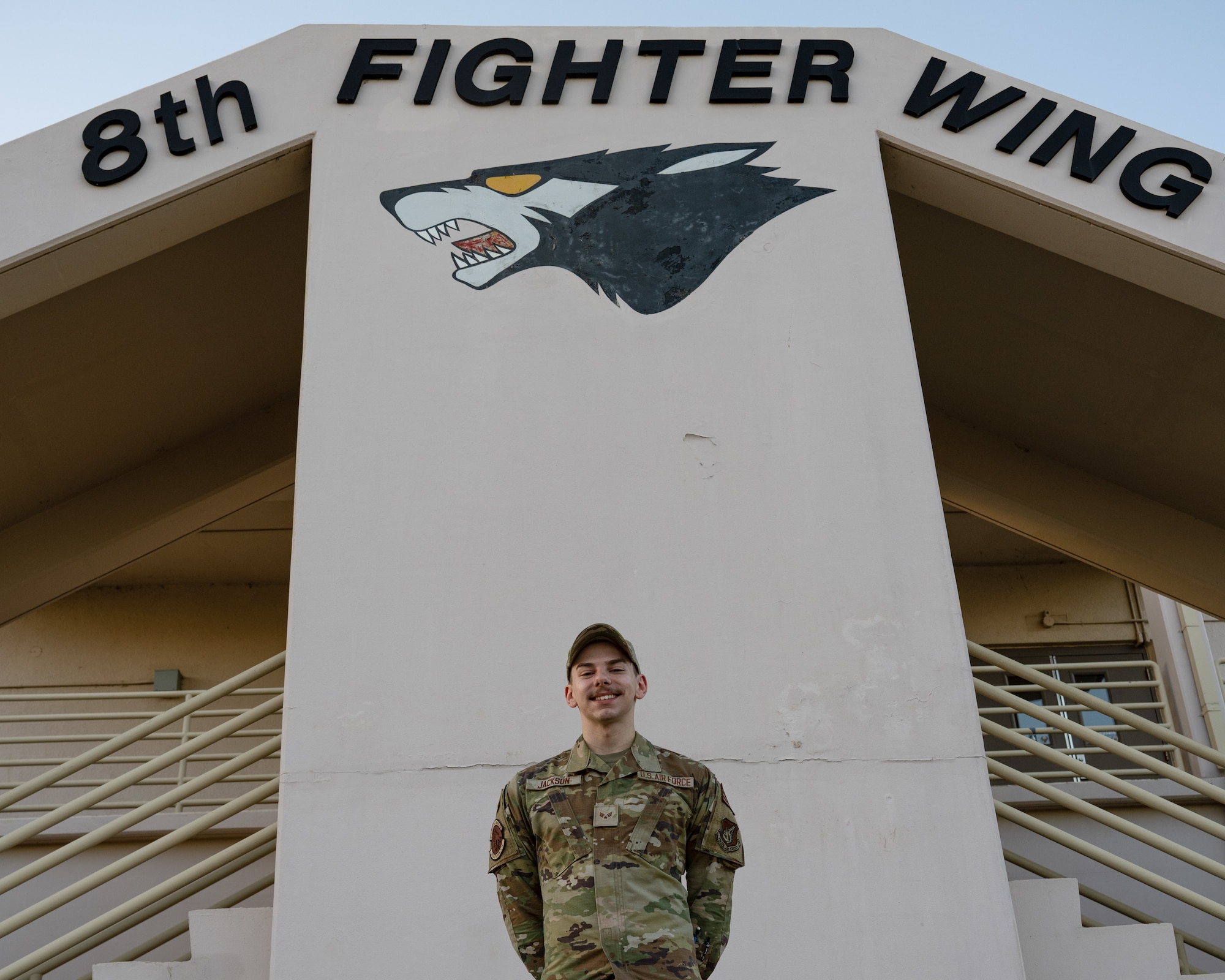 Senior Airman Jaithon Jackson, 8th Fighter Wing emergency actions controller, stands for a photo outside the wing building at Kunsan Air Base, Republic of Korea