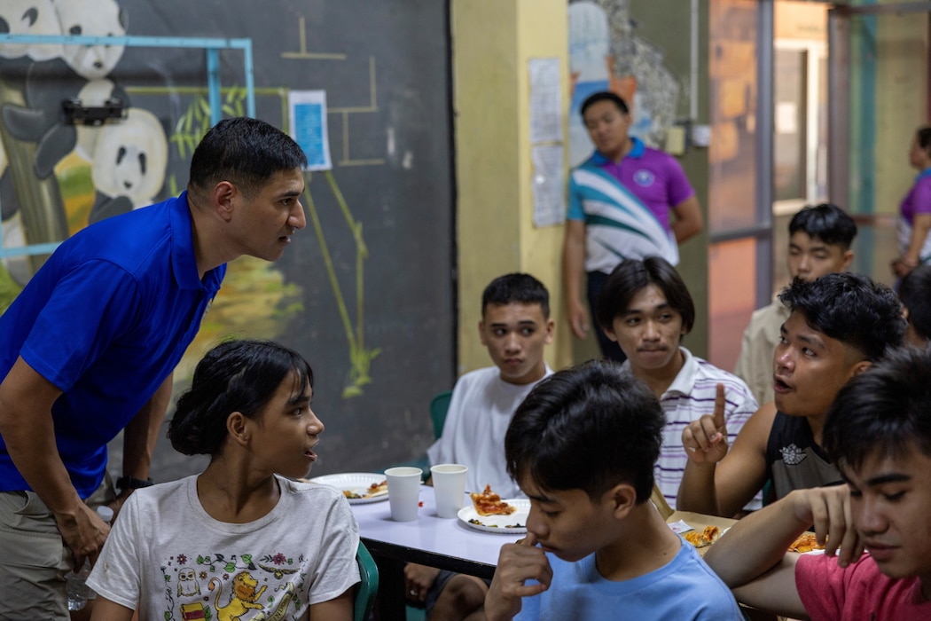 OLONGAPO CITY, Philippines—Navy Lt. Cmdr. Jamil A. Khan, left, chaplain, Military Sealift Command Far East, listens to a Filipino young adult during a community relations event at the Olongapo City Center for Youth during Exercise Balikatan 24, April 19, 2024. Khan offered words of encouragement and advice to the members of the center. BK 24 is an annual exercise between the Armed Forces of the Philippines and the U.S. military designed to strengthen bilateral interoperability, capabilities, trust, and cooperation built over decades of shared experiences. (U.S. Navy photo by Grady T. Fontana)