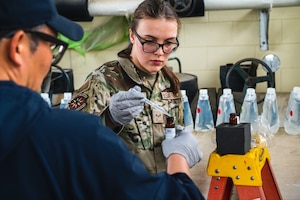 Airman 1st Class Madylynn Lyman uses hydrochloric acid to test water for drinkability.