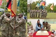 Army Maj. Gen. David Wilson, the commanding general of U.S. Army Sustainment Command, and Col. Ernest J. Lane II, the commander of the 405th Army Field Support Brigade, render honors at Lane’s assumption of command ceremony April 24 on NCO Field at Daenner Kaserne in Kaiserslautern, Germany. And Lane and his family cut the cake at his reception, following the ceremony (Elisabeth Paqué, Training Support Center Kaiserslautern VI photographer)