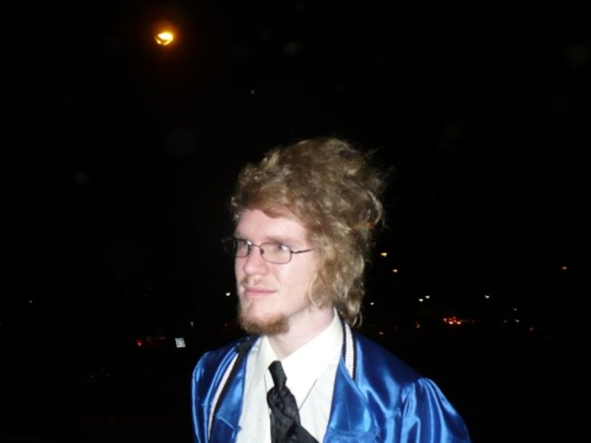 Erik Taylor outside the venue of his high school graduation as the wind was blowing, Conway, Arkansas, 2008.