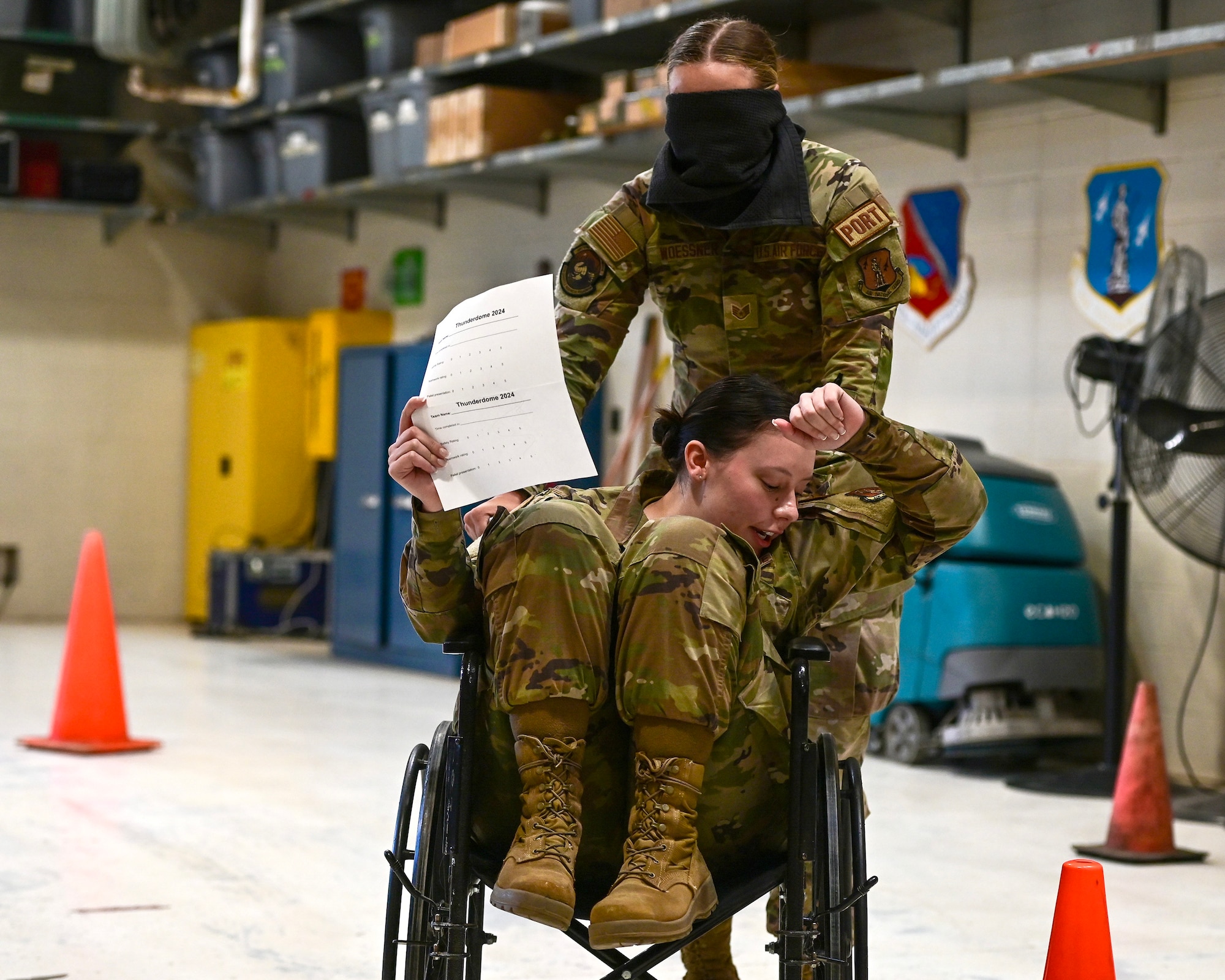 U.S. Air Force Senior Airman Kaitlyn Stahn, front, gives directions to Staff Sgt. Sophie Woessner in St. Paul, Minn., April 5, 2024.
