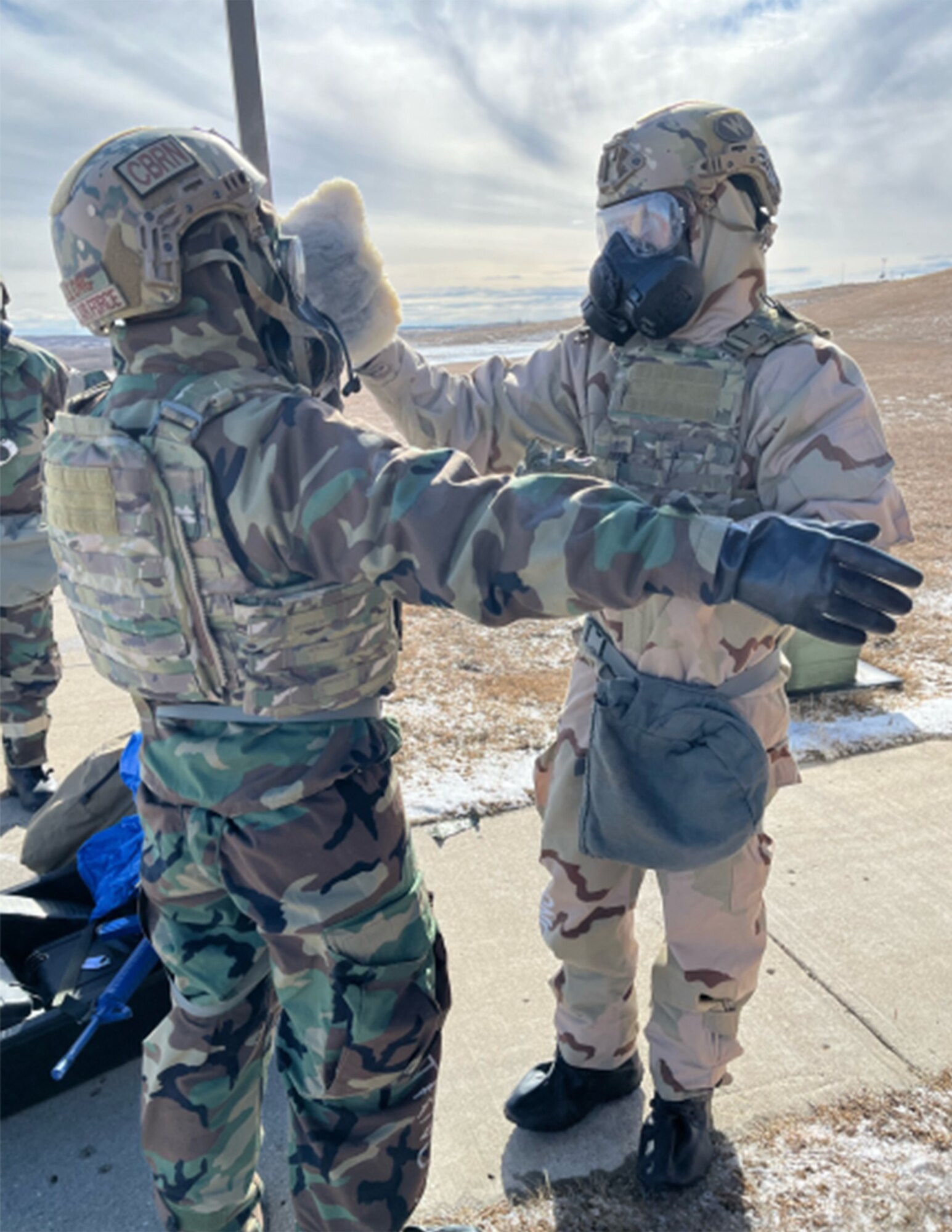 U.S. Air Force Senior Airman Gage Aleong and U.S. Air Force Airman 1st Class Michael Anundson, both from the 341st Missile Wing, perform decontamination operations with an M100 Decontamination Kit at Camp Grafton South, N.D., Feb. 14, 2024.