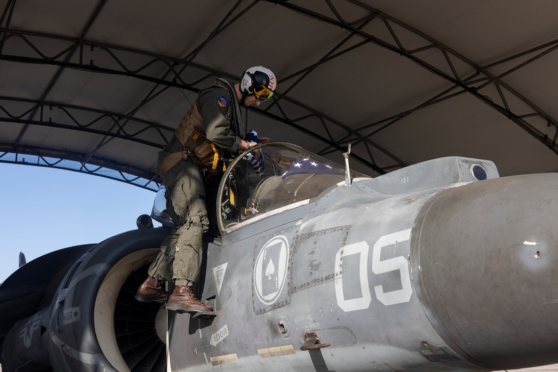 U.S. Marine Corps Capt. Raymond Hower, a native of California and an AV-8B Harrier II jet pilot with Marine Attack Squadron (VMA) 223, places U.S. flags inside an AV-8B Harrier II before a flight honoring his great-uncle Louis A. Conter at Marine Corps Air Station Cherry Point, North Carolina, April 18, 2024. Conter was the last known survivor of the USS Arizona during the attack on Pearl Harbor in 1941 and passed away April 1, 2024. Hower flew U.S. flags and Conter's naval aviator wing insignia during the flight. Conter served in the U.S. Navy from 1939 to 1967. (U.S. Marine Corps photo by Lance Cpl. Orlanys Diaz Figueroa)