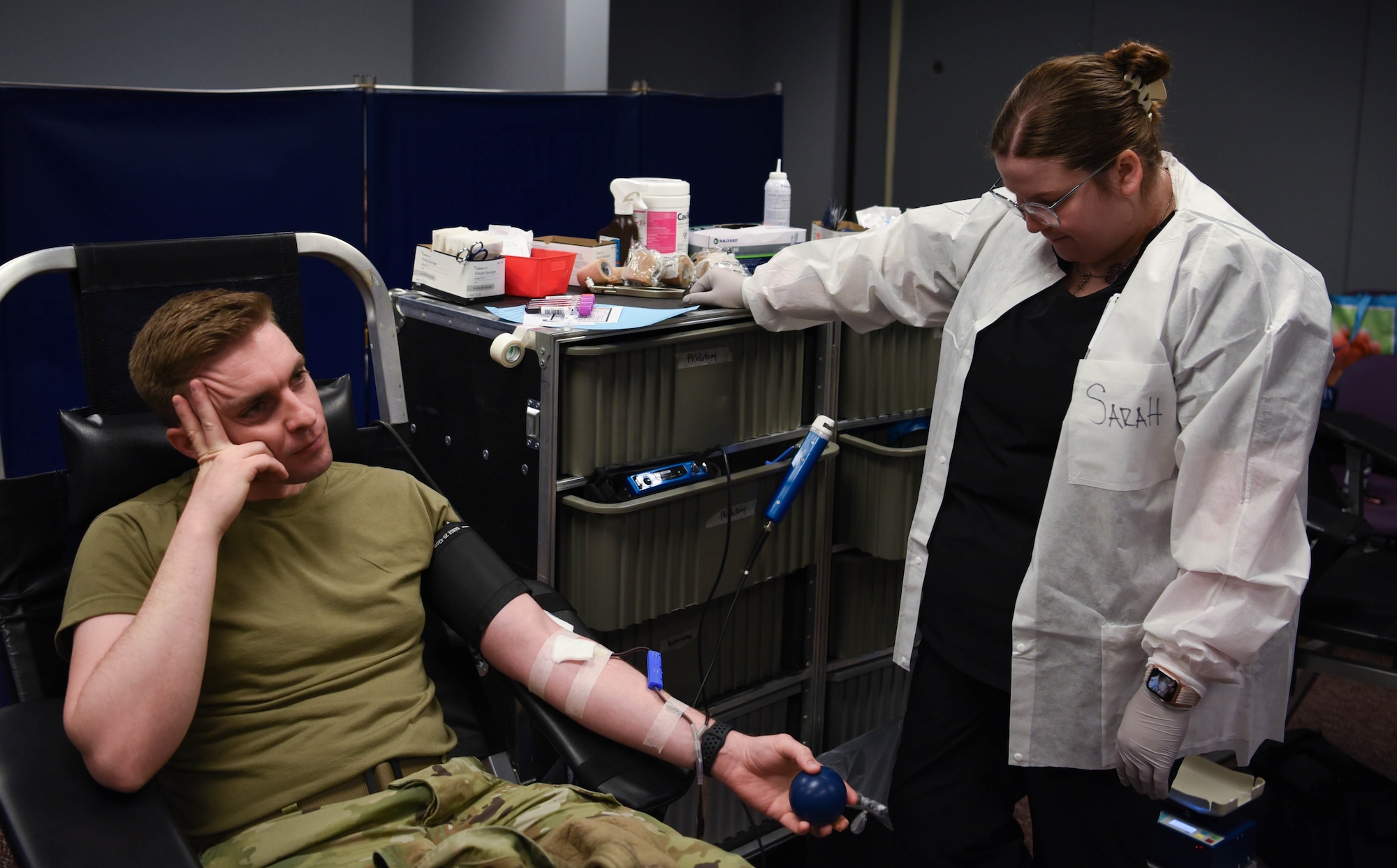 U.S. Air National Guard Member Staff Sgt. Seth Taylor (left) , waits as his blood is drawn by a phlebotomist with the 88th Medical Group for a base wide blood drive on April 5, 2024 in Springfield, Ohio. The 178th Wing participates in The Armed Services Blood Program which provides quality blood products for service members, veterans and their families in both peace and war. (U.S. Air National Guard photo by Airman 1st Class Josh Kaeser)