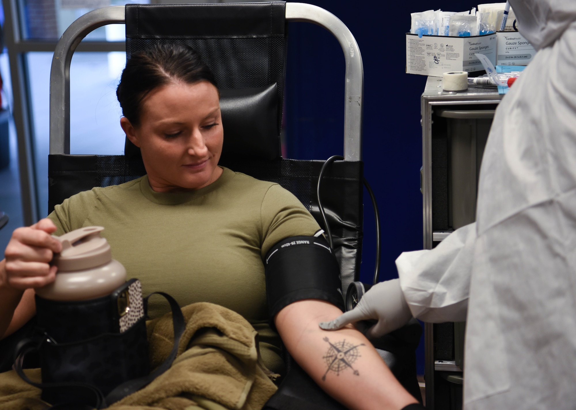U.S. Air National Guard Member Tech. Sgt. Samantha McKinney allows a phlebotomist to assess her arm for a blood drive conducted by the 88th Medical Group for a base wide blood drive on April 5, 2024 in Springfield, Ohio. The 178th Wing participates in The Armed Services Blood Program which provides quality blood products for service members, veterans and their families in both peace and war. (U.S. Air National Guard photo by Airman 1st Class Josh Kaeser)