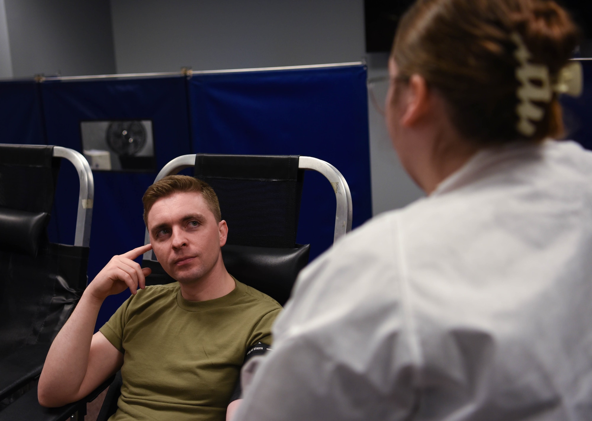 U.S. Air National Guard Member Staff Sgt. Seth Taylor (left), listens to a phlebotomist assigned to the 88th Medical Group for a base wide blood drive on April 5, 2024 in Springfield, Ohio. The 178th Wing participates in The Armed Services Blood Program which provides quality blood products for service members, veterans and their families in both peace and war. (U.S. Air National Guard photo by Airman 1st Class Josh Kaeser)