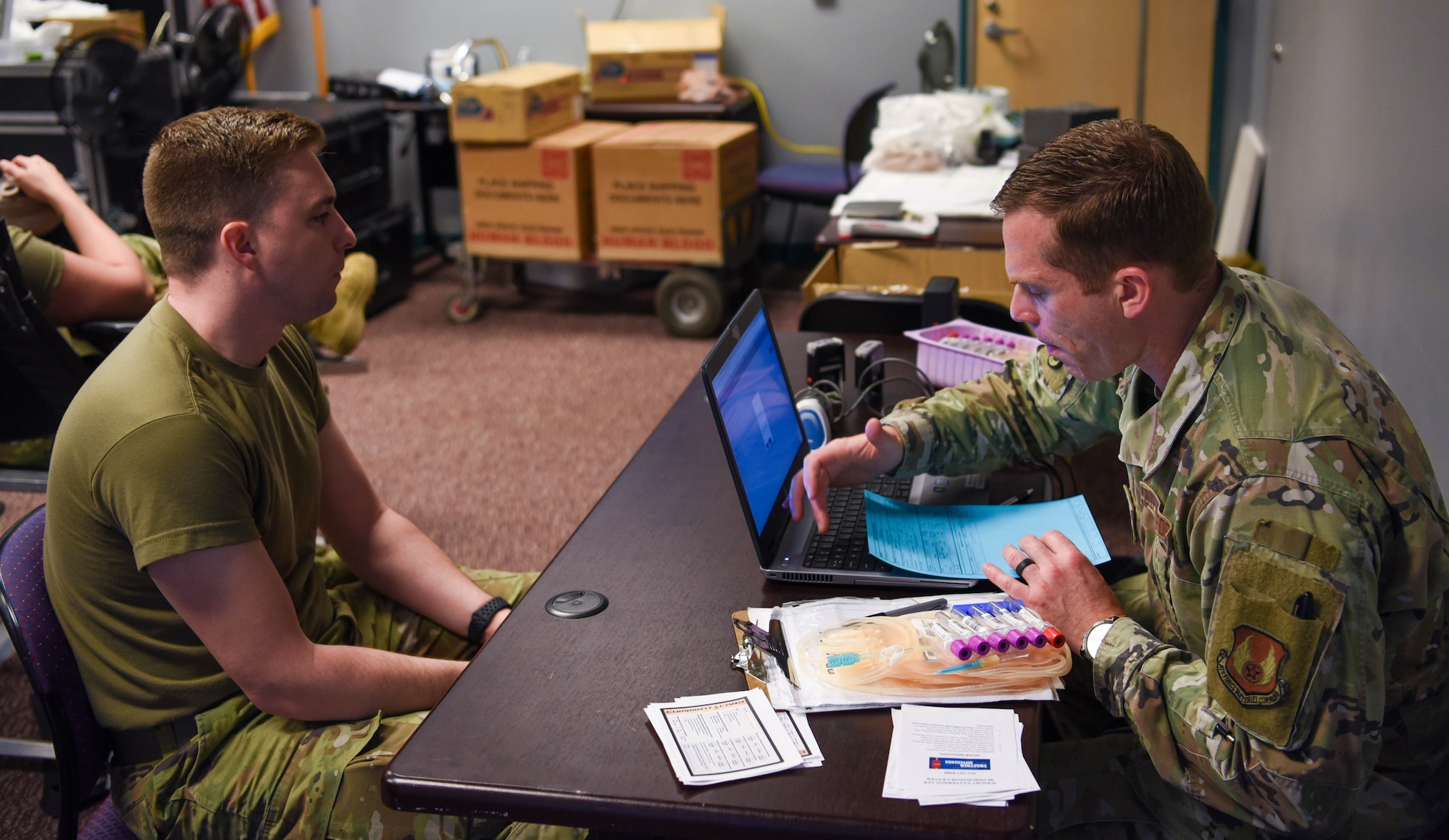 U.S. Air National Guard Member Staff Sgt. Seth Taylor (left), provides medical information to Staff Sgt. Michael Brady (right), As part of a pre-screening process conducted by the 88th Medical Group for a base wide blood drive on April 5, 2024 in Springfield, Ohio. The 178th Wing participates in The Armed Services Blood Program which provides quality blood products for service members, veterans and their families in both peace and war. (U.S. Air National Guard photo by Airman 1st Class Josh Kaeser)
