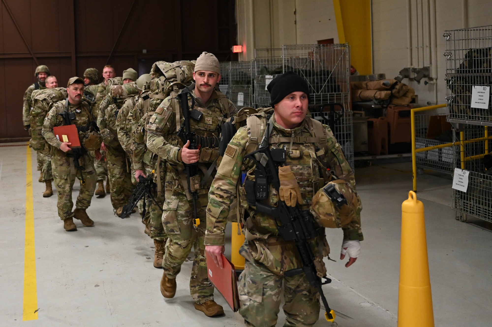 U.S. Air Force security forces members with the 178th Base Defense Squadron prepare to mobilize as part of Operation Guidewire, an Agile Combat Employment exercise, at Springfield-Beckley Air National Guard Base, Ohio, April 5, 2024. Security forces spent multiple nights on Wright-Patterson Air Force base during the exercise, simulating operations in a deployed environment. (U.S. Air National Guard photo by Staff Sgt. Constantine Bambakidis)