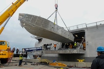An unmanned surface vehicle is craned aboard the Independence-variant littoral combat ship USS Canberra (LCS 30), as a part of the first embarkation of the Mine Countermeasures (MCM) mission package, April 23. The MCM mission package is an integrated suite of unmanne