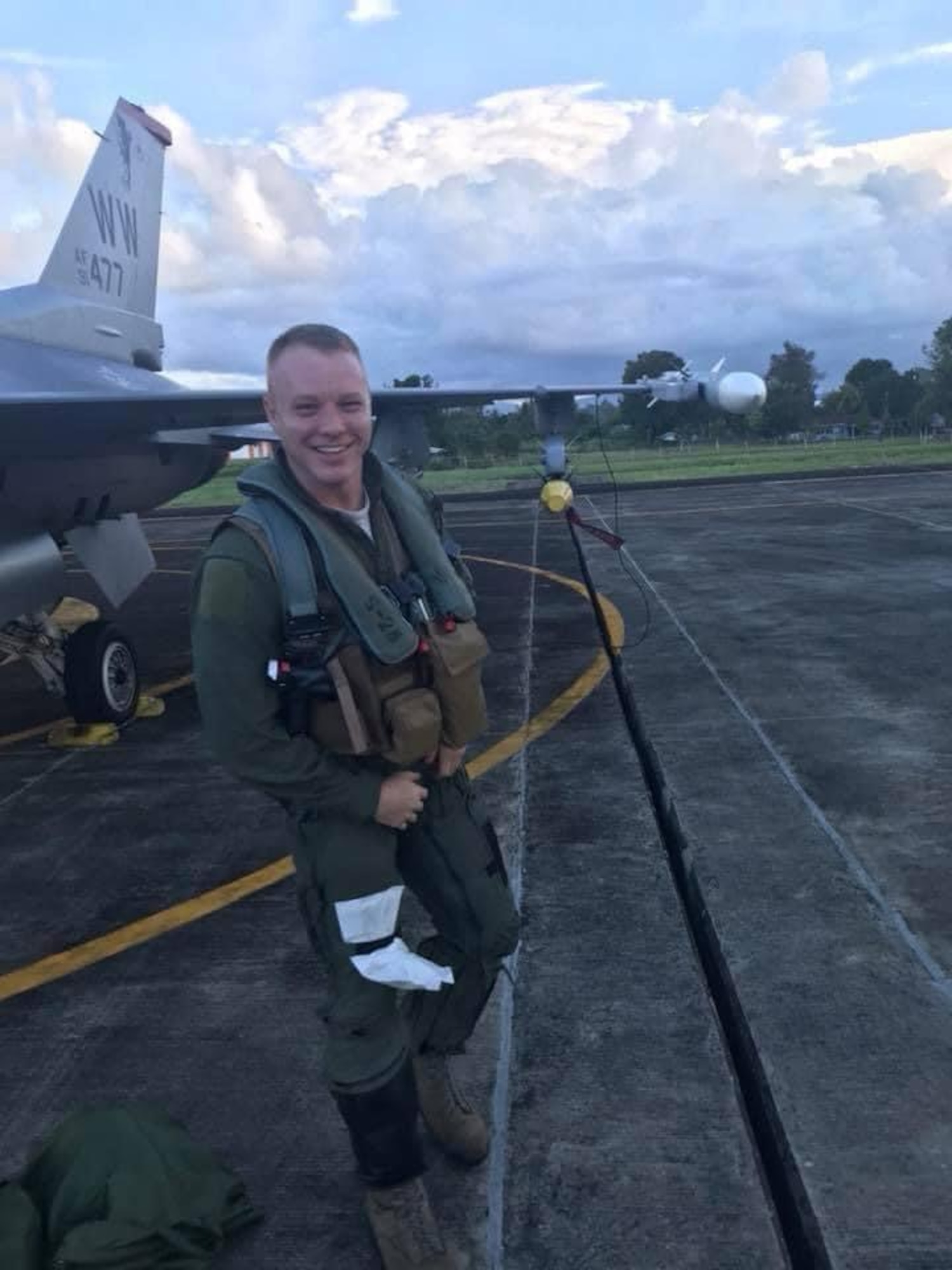Airman in a flight suit smiles