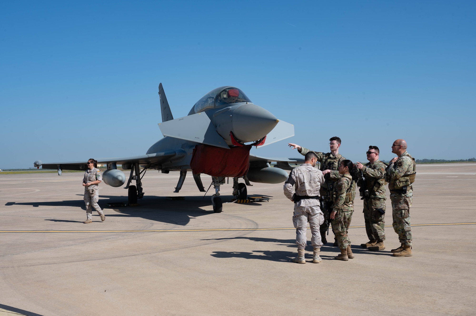 U.S. Air Force security forces defenders perform a combined patrol with a Spanish air force defender