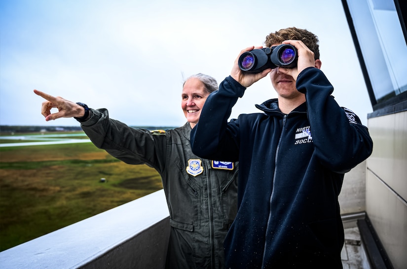 U.S. Air Force Col. Elizabeth Hanson, 305th Air Mobility Wing commander, points to the flight line at Joint Base McGuire-Dix-Lakehurst, N.J., April 20, 2024. The Mid-Air Collision Avoidance program is designed to ensure safety practices are observed between military and civilian pilots who share a common airspace. (U.S. Air Force photo by Senior Airman Matt Porter)
