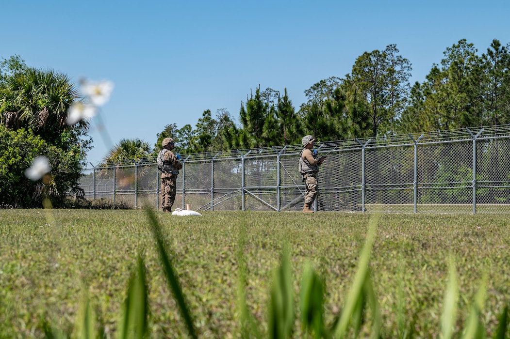 U.S. Air Force Airmen assigned to the 23rd Logistics Readiness Squadron patrol the perimeter fence while the 23rd Wing inspection team simulate a protest during Exercise Ready Tiger 24-1 at Avon Park Air Force Range, Florida, April 12, 2024. As part of the Multi-Capable Airman initiative, Airmen from multiple career fields augmented as security forces to ensure the contingency location’s safety. Ready Tiger 24-1 is a readiness exercise demonstrating the 23rd Wing’s ability to plan, prepare and execute operations and maintenance to project air power in contested and dispersed locations, defending the United States’ interests and allies. (U.S. Air Force photo by Airman 1st Class Leonid Soubbotine)