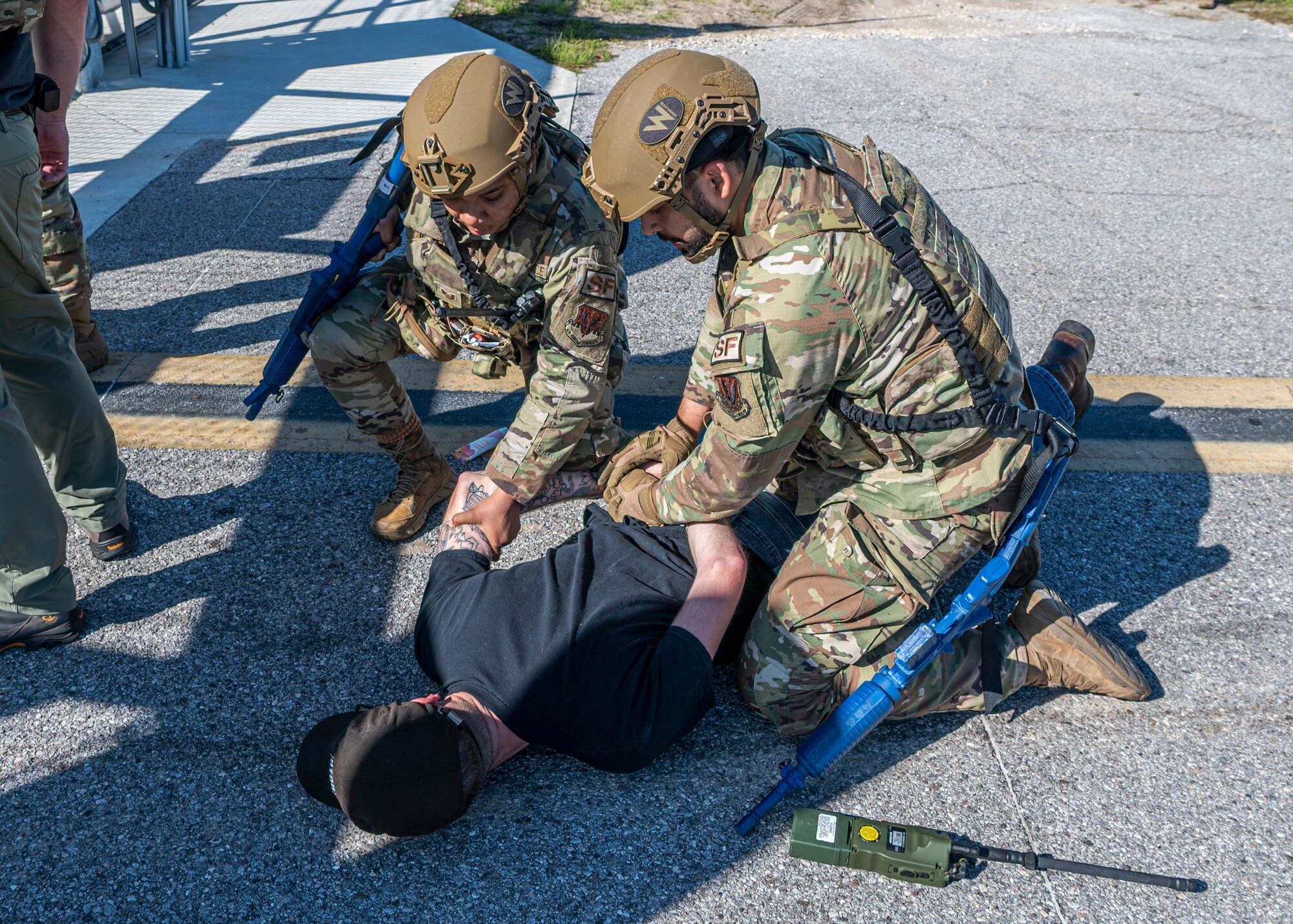 U.S. Air Force Airmen assigned to the 23rd Security Forces Squadron detain an Airman assigned to the 23rd Wing inspection team during Exercise Ready Tiger 24-1 at Avon Park Air Force Range, Florida, April 11, 2024. Building upon previously simulated protest, the inspectors implemented a more violent approach and tried to breach the base perimeter to test security force’s response. Built upon Air Combat Command's directive to assert air power in contested environments, Exercise Ready Tiger 24-1 aims to test and enhance the 23rd Wing’s proficiency in executing Lead Wing and Expeditionary Air Base concepts through Agile Combat Employment and command and control operations. (U.S. Air Force photo by Airman 1st Class Leonid Soubbotine)