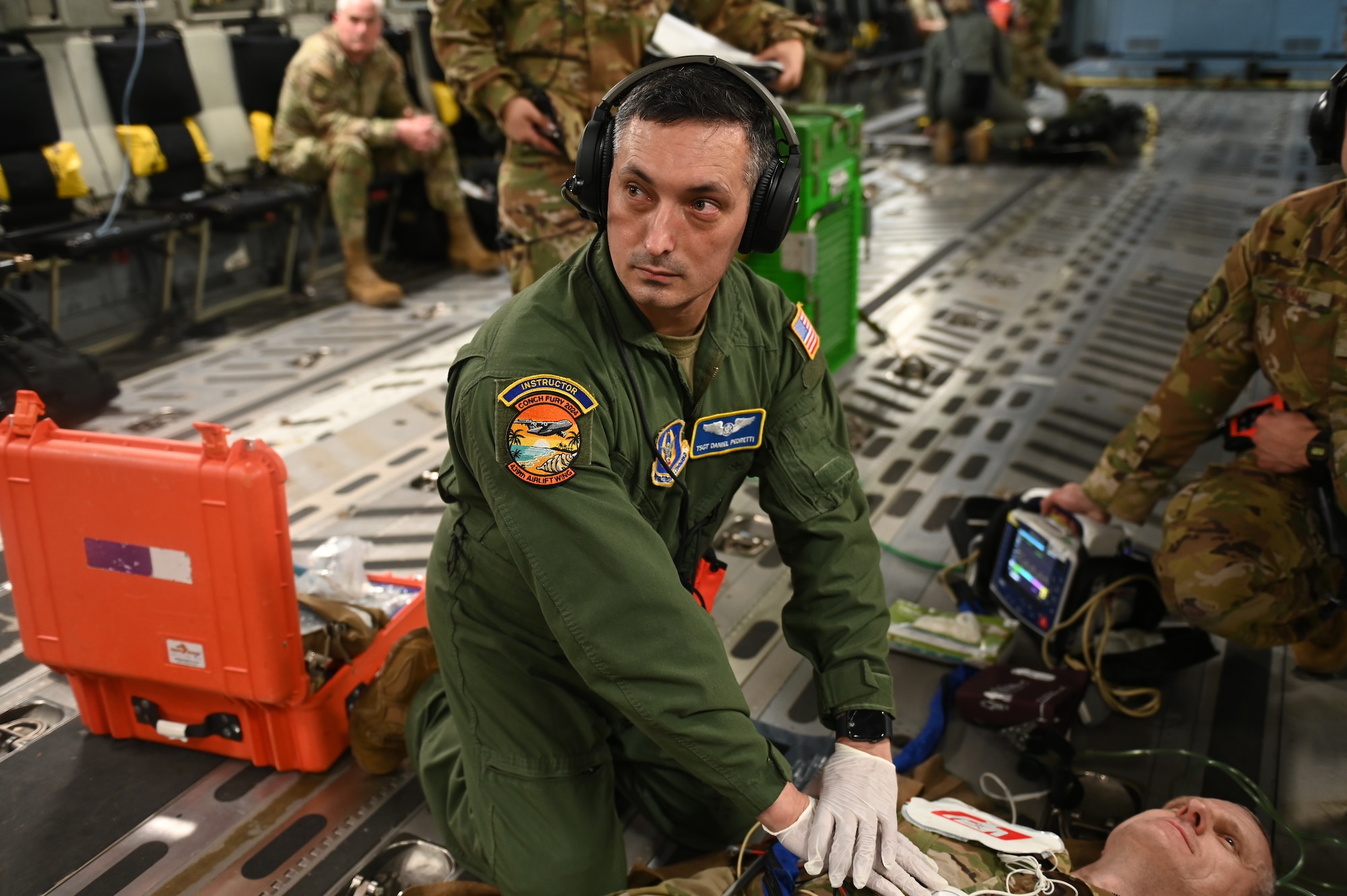 A U.S Air Force sergeant practices CPR on a medical mannequin onboard a C-17 Globemaster at Muniz Air National Guard Base, Puerto Rico during exercise Conch Fury 2024.