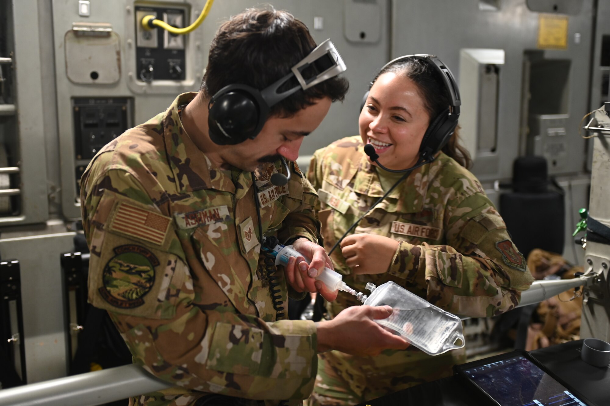 A U.S. Air Force flight nurse practices administering intravenous fluids to a U.S. Air Force sergeant aboard a C-17 Globemaster during exercise Conch Fury 2024.