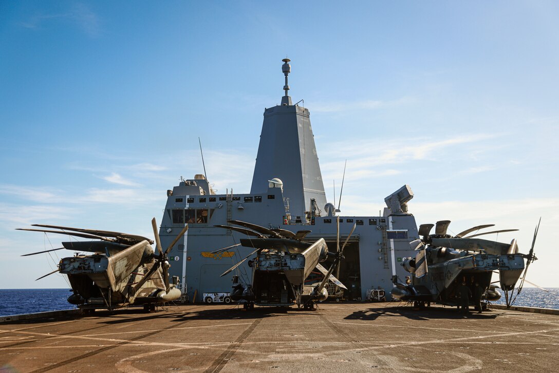 U.S. Marines assigned to Marine Medium Tiltrotor Squadron (VMM) 165 (Reinforced), 15th Marine Expeditionary Unit, prepare CH-53E Super Stallions attached to VMM-165 (Rein.), 15th MEU, for flight operations aboard the amphibious transport dock USS Somerset (LPD 25) in the South China Sea April 11, 2024. Somerset and embarked elements of the 15th MEU are conducting routine operations in the U.S. 7th Fleet area of operations. 7th Fleet is the U.S. Navy's largest forward-deployed numbered fleet, and routinely interacts and operates with allies and partners in preserving a free and open Indo-Pacific region. (U.S. Marine Corps photo by Cpl. Aidan Hekker)