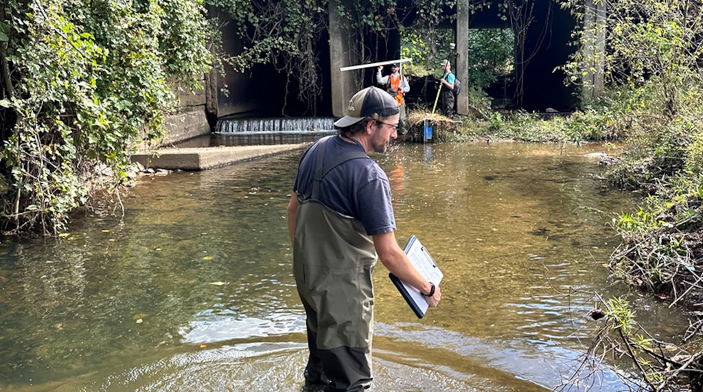 Man in water doing testing.