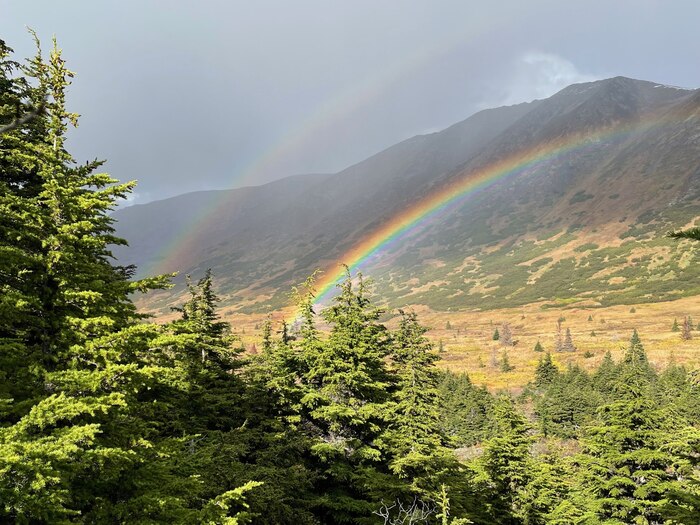 Image of mountains and rainbow.