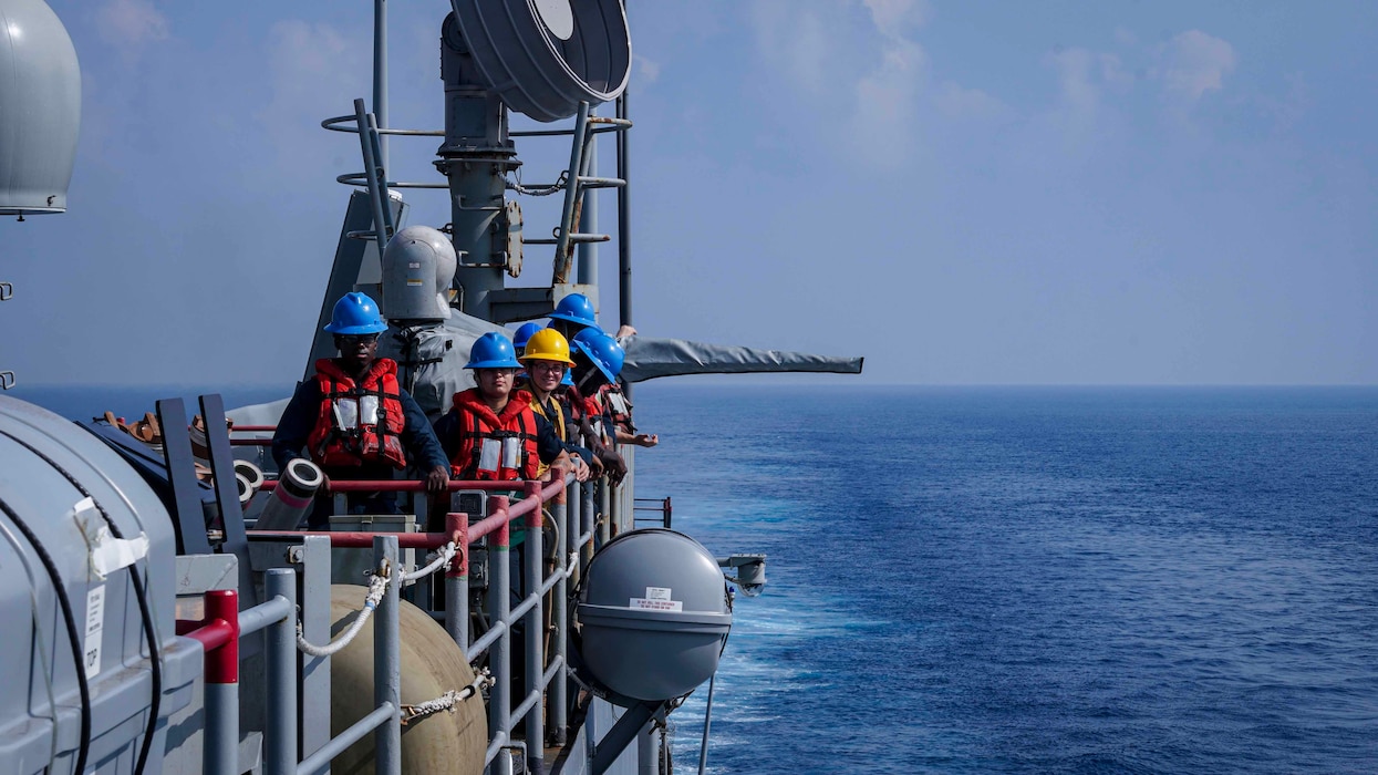 Sailors prepare to conduct a replenishment-at-sea aboard the amphibious dock landing ship USS Harpers Ferry (LSD 49)