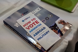 A voting assistance brochure and workbook sit on a table at Moody Air Force Base, Georgia, April 24, 2024. The Federal Voting Assistance Program hosted a workshop to train Voting Assistance Officers to educate and provide resources on absentee voting to military members. (U.S. Air Force photo by Airman 1st Class Leonid Soubbotine)