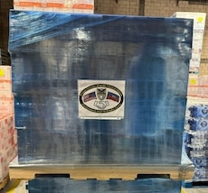 Pallets of oral hydration fluid sit in a warehouse in Doral, Fla. April 23, 2024, prior to transport to Toussaint Louverture International Airport, Port-au-Prince, Haiti.