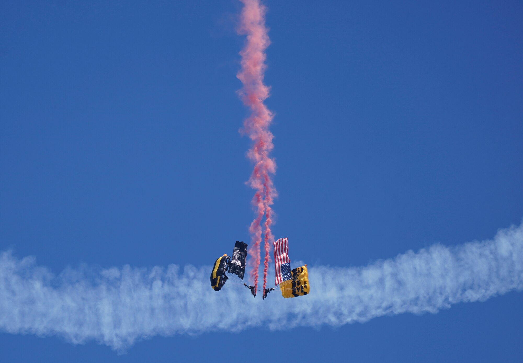 Members of the U.S. Army Golden Knights descend from the sky during the Beyond the Horizon Air and Space Show