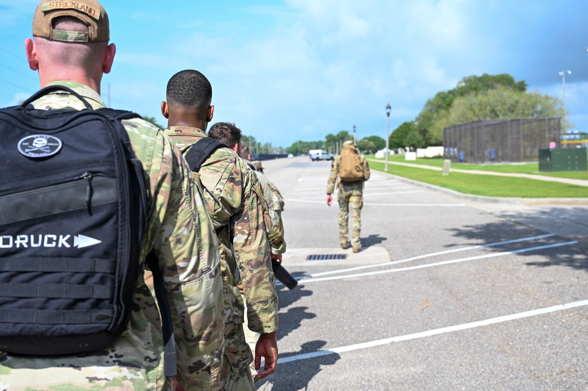 U.S. Air Force personnel ruck around base during Warrior Day as part of LEAD-a-Thon at Keesler Air Force Base, Mississippi, April 19, 2024.