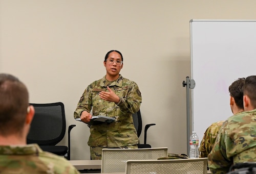 A guest speaker talks with Airmen