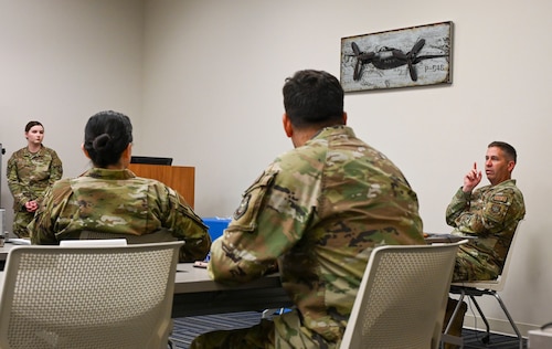 A squadron commander speaks with Airmen