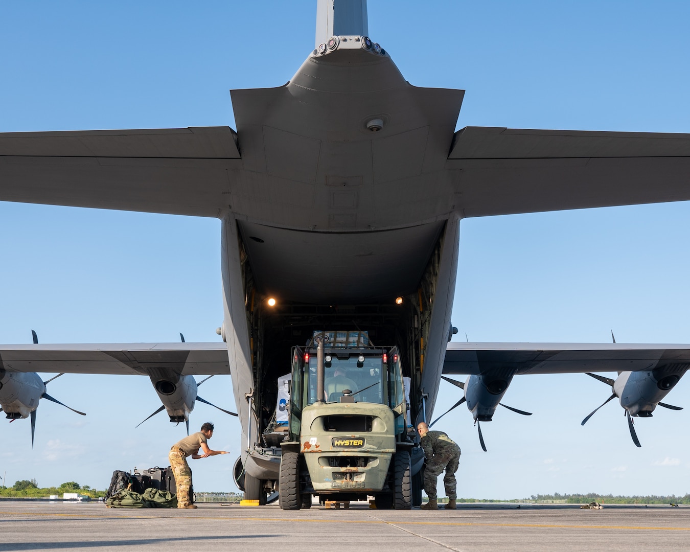 Pallets of oral hydration fluid are loaded onto a U.S. Air Force C-130 Hercules at Homestead Air Reserve Base.