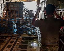 Pallets of oral hydration fluid are loaded onto a U.S. Air Force C-130 Hercules at Homestead Air Reserve Base.