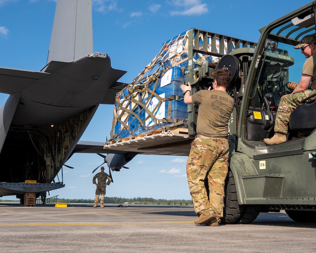 Pallets of oral hydration fluid are loaded onto a U.S. Air Force C-130 Hercules at Homestead Air Reserve Base.