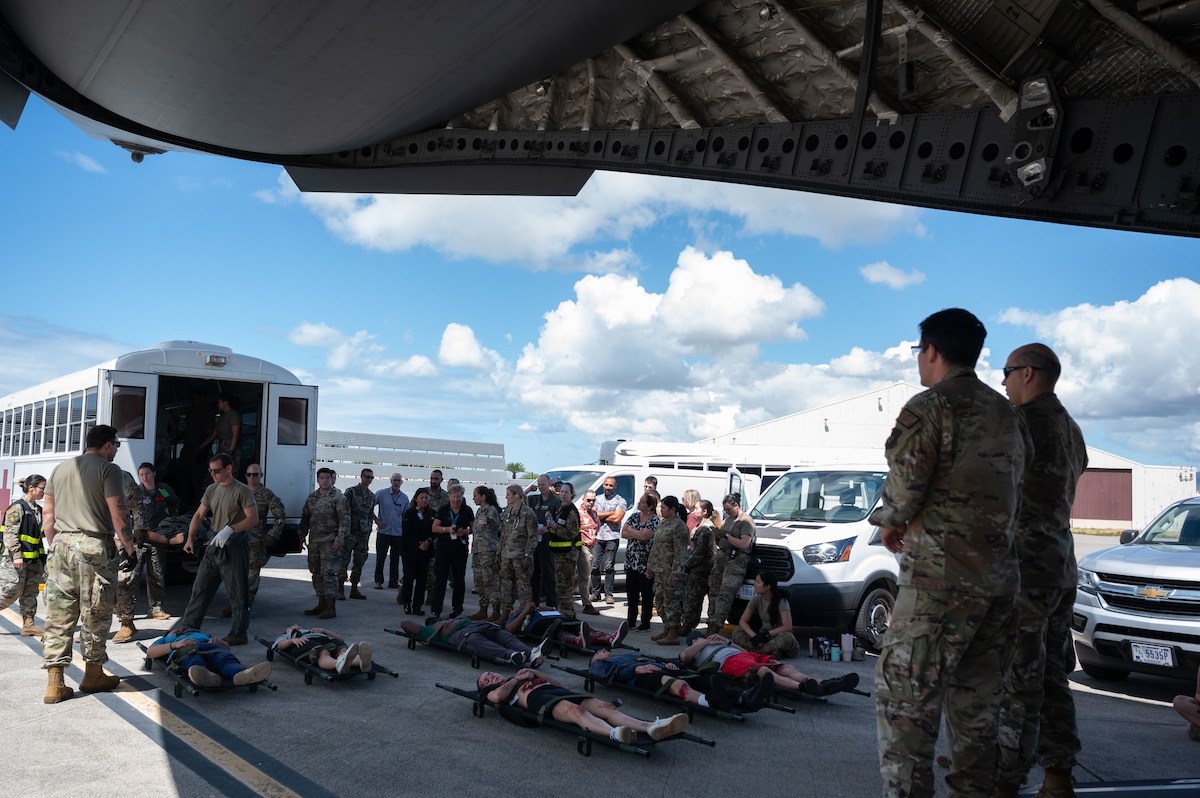 Fifteen medical professionals from the island of Oahu visited Joint Base Pearl Harbor-Hickam to get eyes on the U.S. Air Force’s aeromedical evacuation system and its capabilities, April 10, 2024. The visitors were able to witness the 15th Medical Group conduct an exercise, establishing an En Route Patient Staging System and watched as simulated patients were loaded onto an Ambulance Bus and taken to a C-17 Globemaster III transport aircraft. (U.S. Air Force photo by Tech. Sgt. Hailey Haux)