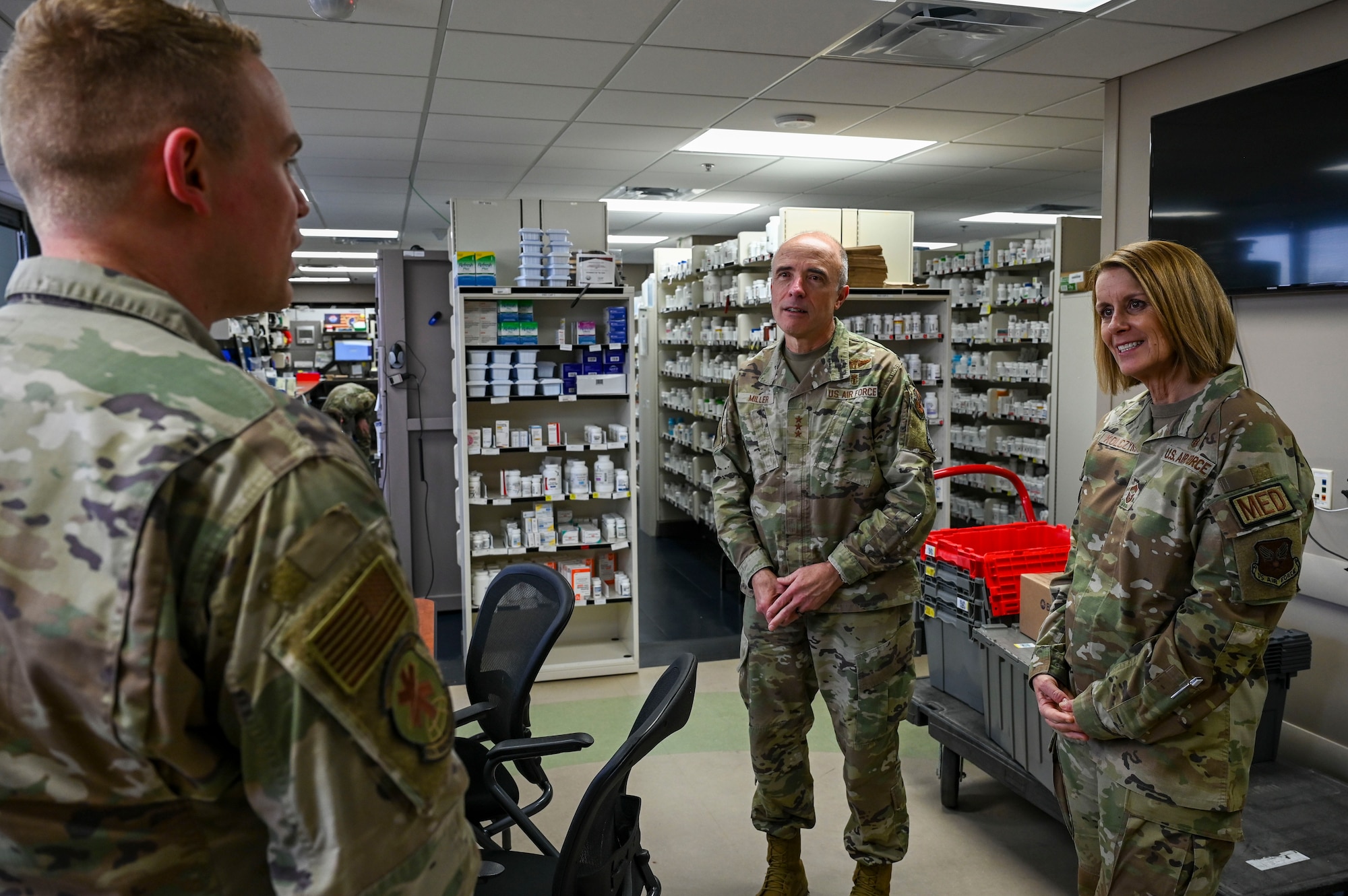 Air Force personnel talk in a pharmacy.