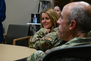 An Air Force Chief sits at a table.