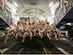 An all-female air and ground crew pose together at Yokota Air Base, Japan, on March 27, 2024 in recognition of Women's History Month. The 22-member team transported nearly 12,500 pounds of cargo to its next destination. (U.S. Air Force photo by 2d Lt. Christopher Winters)